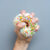 Hand,Squeezes,The,Doughnut.,One,Donut,With,White,Icing.,An